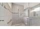 Tiled walk-in shower with glass surround and window at 8107 Sw 92Nd Cir, Ocala, FL 34481