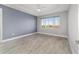 Relaxing bedroom with wood-look tile flooring, a tray ceiling with fan, and a large window at 8107 Sw 92Nd Cir, Ocala, FL 34481