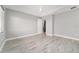 Neutral bedroom with wood-look tile flooring, tray ceiling, and natural light at 8107 Sw 92Nd Cir, Ocala, FL 34481