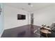 Bonus room with a dark floor, chair, and TV mounted on the wall at 8107 Sw 92Nd Cir, Ocala, FL 34481