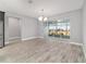 Bright dining room featuring wood-look tile floors, modern chandelier, and sliding glass doors to the backyard at 8107 Sw 92Nd Cir, Ocala, FL 34481