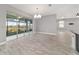 Bright dining room with wood-look tile flooring, modern chandelier, and lanai access at 8107 Sw 92Nd Cir, Ocala, FL 34481