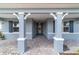 Inviting entryway with stone pavers, white columns, and a stylish front door with sidelights at 8107 Sw 92Nd Cir, Ocala, FL 34481