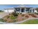 Charming single-story home with a colorful landscaped front yard and blue exterior at 8107 Sw 92Nd Cir, Ocala, FL 34481