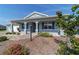 Charming single-story home featuring a well-manicured lawn and inviting front porch at 8107 Sw 92Nd Cir, Ocala, FL 34481