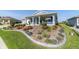 Landscaped front yard with fresh green grass and a garden with colorful flowers at 8107 Sw 92Nd Cir, Ocala, FL 34481