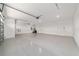 Three-car garage featuring epoxy flooring and two garage doors at 8107 Sw 92Nd Cir, Ocala, FL 34481