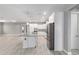 Open kitchen features white cabinets, stainless steel appliances, and an island with granite countertops at 8107 Sw 92Nd Cir, Ocala, FL 34481