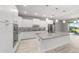 Spacious kitchen with stainless steel appliances, island with granite counters, and white cabinetry at 8107 Sw 92Nd Cir, Ocala, FL 34481