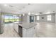 Bright open-concept kitchen featuring a large island, stainless steel appliances, and seamless flow at 8107 Sw 92Nd Cir, Ocala, FL 34481