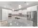 Stylish kitchen featuring a large island, granite countertops, and stainless steel appliances at 8107 Sw 92Nd Cir, Ocala, FL 34481
