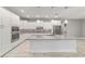 White kitchen with stainless appliances, mosaic backsplash, granite counters, and an island at 8107 Sw 92Nd Cir, Ocala, FL 34481