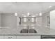 Open-concept living room features a ceiling fan, tray ceiling, recessed lights, and access to the outdoors at 8107 Sw 92Nd Cir, Ocala, FL 34481