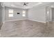 Large living room with a tray ceiling, ceiling fan, and sliding glass doors to the patio at 8107 Sw 92Nd Cir, Ocala, FL 34481
