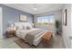 Relaxing main bedroom with a tray ceiling, light blue accent wall, and large window, creating a peaceful retreat at 8107 Sw 92Nd Cir, Ocala, FL 34481
