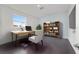Office features a modern desk, chair, and a bookshelf with a collection of books at 8107 Sw 92Nd Cir, Ocala, FL 34481