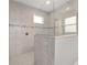 The shower features a glass surround, built-in bench and a ledge between the spaces at 8107 Sw 92Nd Cir, Ocala, FL 34481