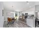 Modern kitchen and dining area with stainless steel appliances, white cabinets, and easy access to the backyard via sliding doors at 8164 Sw 131St Pl, Ocala, FL 34473