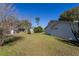 Side view of a house with a grassy backyard and blue skies at 8231 Sw 108Th Loop, Ocala, FL 34481