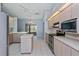 Kitchen featuring stainless steel appliances, light wood cabinets and an island with seating at 8231 Sw 108Th Loop, Ocala, FL 34481