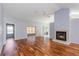 Spacious living room featuring hardwood floors, a fireplace, and sliding glass doors at 8231 Sw 108Th Loop, Ocala, FL 34481