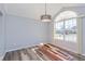 Bright living room featuring a large window, new flooring, and modern light fixture at 8231 Sw 108Th Loop, Ocala, FL 34481