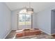 Bright living room featuring a large window, new flooring, and modern light fixture at 8231 Sw 108Th Loop, Ocala, FL 34481