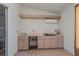 Sunroom featuring an outdoor kitchen with light wood cabinets and tile flooring at 8231 Sw 108Th Loop, Ocala, FL 34481