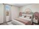 Comfortable bedroom featuring a decorative headboard and a large window at 8673 Sw 44Th Ter, Ocala, FL 34476