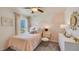 Cozy bedroom with soft pink accents, natural light, and comfortable furnishings at 8679 Sw 44Th Ter, Ocala, FL 34476