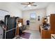 Bedroom showing home office with a treadmill and a large window offering natural light at 8953 Sw 50Th Ter, Ocala, FL 34476