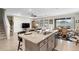 Granite kitchen island with bar seating overlooks the dining area and living room at 8953 Sw 50Th Ter, Ocala, FL 34476