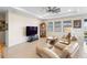 Bright living room featuring tile floors, modern ceiling fan and large windows at 8953 Sw 50Th Ter, Ocala, FL 34476