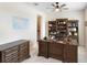 Home office features built-in bookshelves, a large desk, and natural light at 8953 Sw 50Th Ter, Ocala, FL 34476