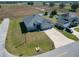 Aerial view of the home, showcasing the well-manicured lawn, long driveway, and three-car garage at 9105 Se 55Th Ter, Ocala, FL 34480