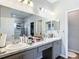 Bathroom featuring double sinks, white counter tops, and a large mirror at 9105 Se 55Th Ter, Ocala, FL 34480