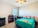 Cozy bedroom with a ceiling fan, carpet flooring, a window and cute decorations at 9105 Se 55Th Ter, Ocala, FL 34480