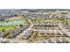 Panoramic aerial shot of a Primary-planned community with diverse home styles, lush landscaping, and recreational amenities at 9184 Sw 57Th Place Rd, Ocala, FL 34481