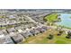 Expansive aerial view of a residential community next to a golf course and serene lake at 9184 Sw 57Th Place Rd, Ocala, FL 34481