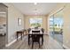 Bright dining room features modern lighting, neutral walls, and a sliding glass door to the patio at 9184 Sw 57Th Place Rd, Ocala, FL 34481