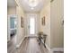 Inviting foyer with wood-look flooring, stylish lighting, and a decorative glass door at 9184 Sw 57Th Place Rd, Ocala, FL 34481