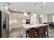 Modern kitchen featuring stainless steel appliances, a center island with bar seating, and stylish pendant lights at 9184 Sw 57Th Place Rd, Ocala, FL 34481