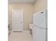 This laundry room features a door and a refrigerator at 9184 Sw 57Th Place Rd, Ocala, FL 34481