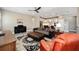 Open concept living room with a ceiling fan, leather sofa, and a view of the kitchen and dining area at 9184 Sw 57Th Place Rd, Ocala, FL 34481