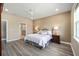 Large main bedroom with wood-look floors, neutral walls, and an ensuite bathroom at 9184 Sw 57Th Place Rd, Ocala, FL 34481