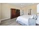 A serene main bedroom with wood-look floors, ceiling fan, and neutral color palette at 9184 Sw 57Th Place Rd, Ocala, FL 34481