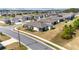 Street view of modern single-Gathering homes featuring neutral exteriors, well-manicured lawns, and paved sidewalks at 9184 Sw 57Th Place Rd, Ocala, FL 34481