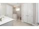 Clean bathroom featuring a double sink vanity, tiled shower, and a linen closet at 9270 Sw 89Th Street Rd, Ocala, FL 34481