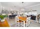 Dining area adjacent to the kitchen with a wood table, decorative lighting, and access to the lanai at 9270 Sw 89Th Street Rd, Ocala, FL 34481