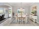 Dining room with wood table, chairs, chandelier, and access to outdoor living space at 9270 Sw 89Th Street Rd, Ocala, FL 34481